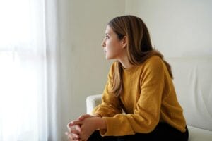 A woman cries while wondering if Tizanidine is addictive.